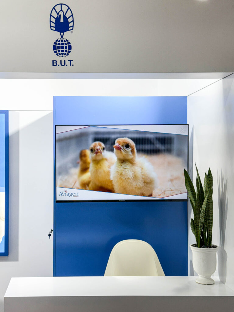 42-inch screen at Aviagen booth presenting turkey breeding technologies and company information