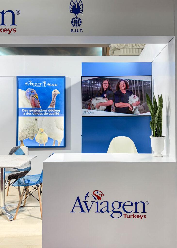 Efficiently designed exhibition stand with reception desk, seating area, and display elements